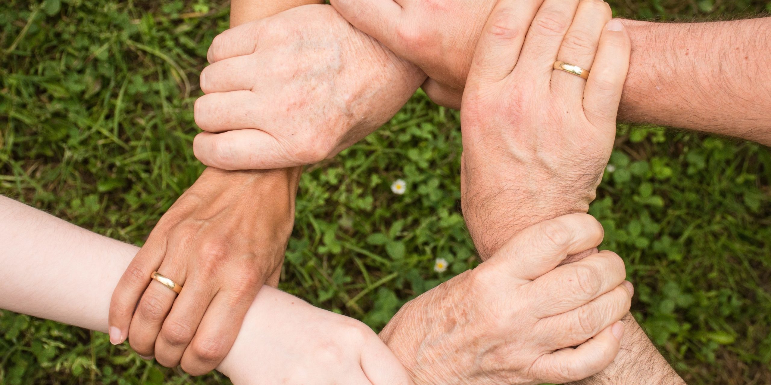 remote team hands Manage Remote Distributed Teams